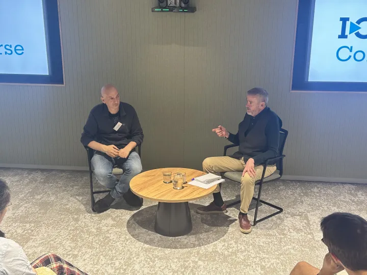 Dr Martin Pule talks to Dr Rick Fagan in front of a crowd at I-O Converse