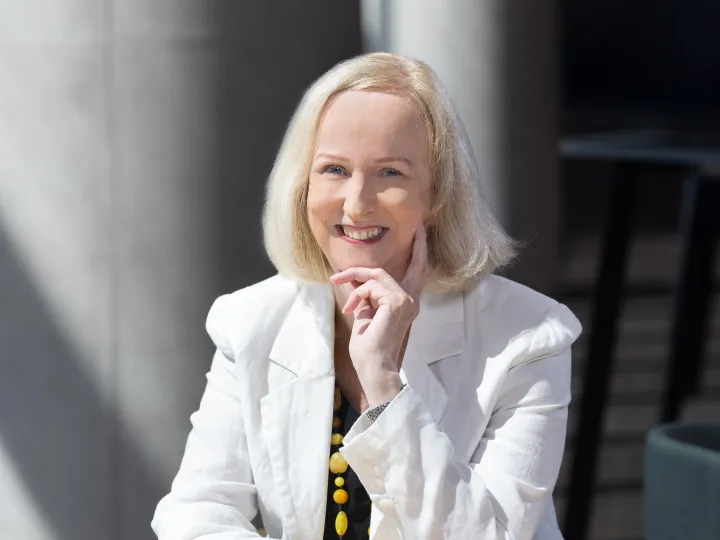 Dr Anne Lane smiling at the camera in a white jacket 