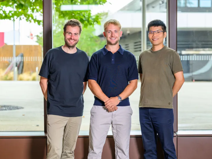 AcouBatt Team photo of three men, two white, one Asian. Smiling at the camera. 