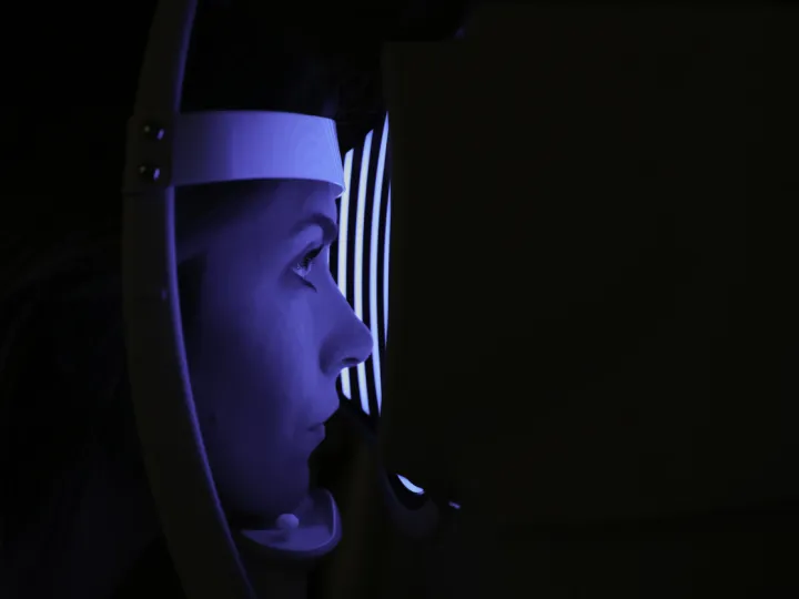 Lady taking part in an eye examination. 
