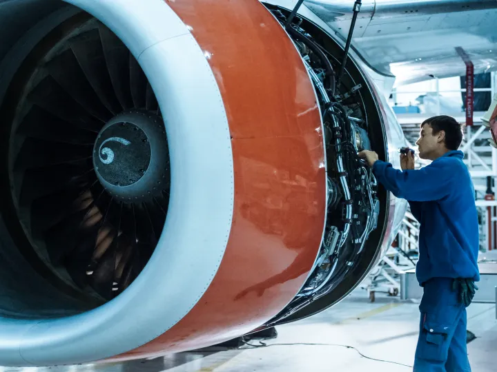 Male mechanic inspects a turbo engine