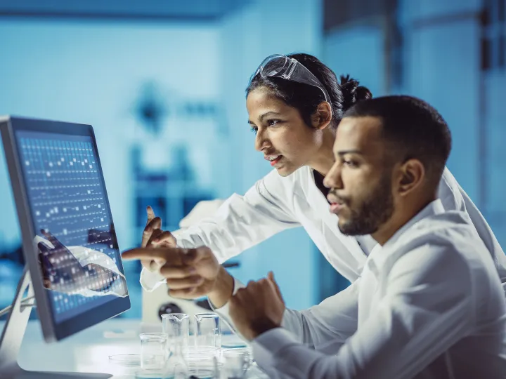 Scientists working in the lab, using a touch screen