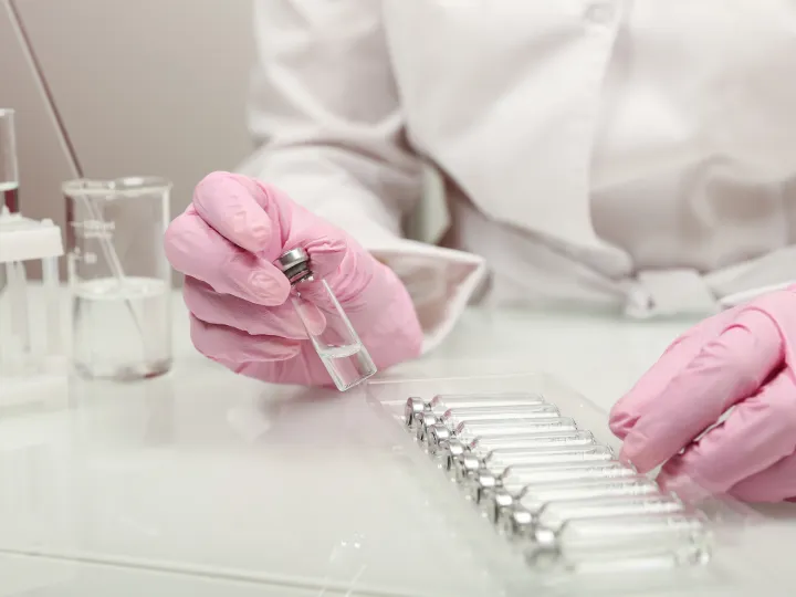 Doctor holding a vial of medicine in the laboratory 