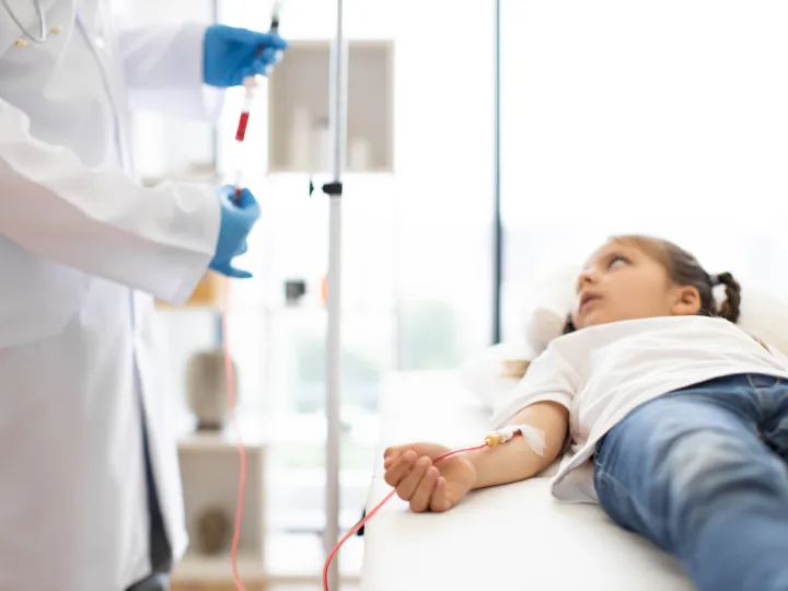 Young girl on a drip with medical professional