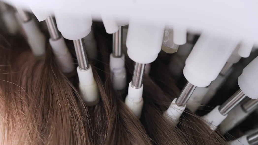 Close up of ultrasound wands in a woman's hair
