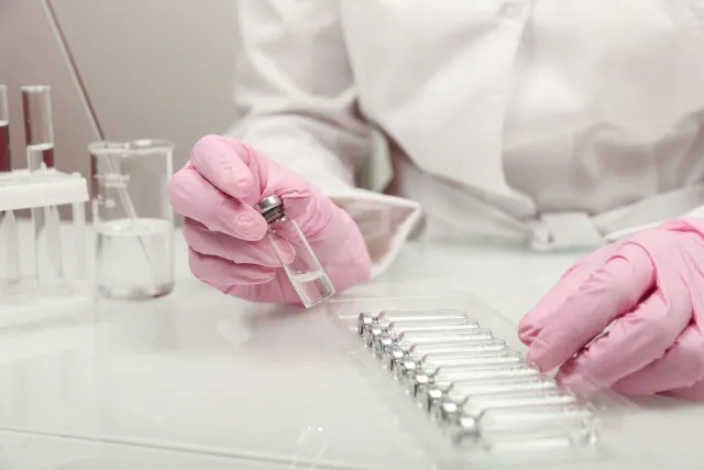 Doctor holding a vial of medicine in the laboratory 