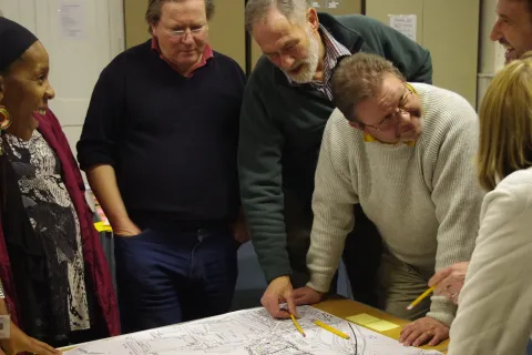 community group discussing over a map