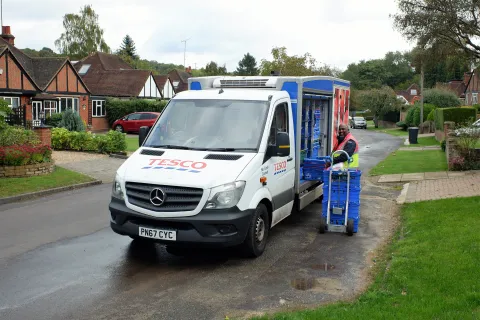grocery delivery truck unloading in suburbs