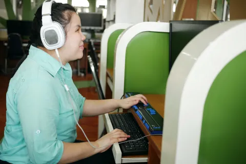 Lady with blindness disability using an assistive technology device. 