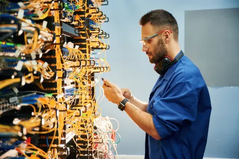 Man looking at internet modems