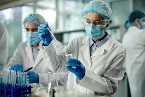 Mature scientist working on antiviral drug in laboratory.