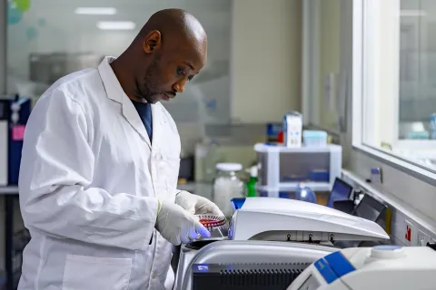 Male researcher using a machine