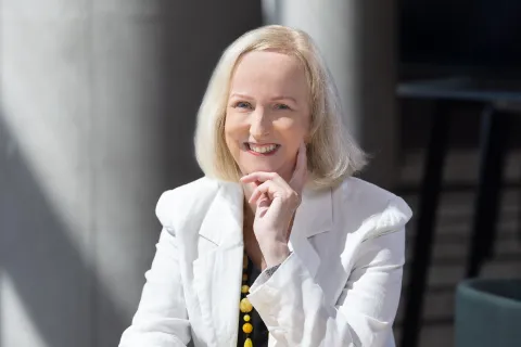 Dr Anne Lane smiling at the camera in a white jacket 