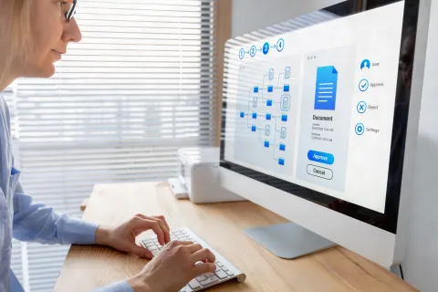 Woman working with file manager on computer screen at the office 