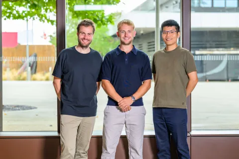 AcouBatt Team photo of three men, two white, one Asian. Smiling at the camera. 