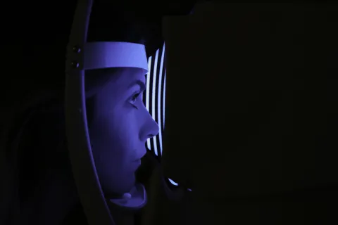 Lady taking part in an eye examination. 