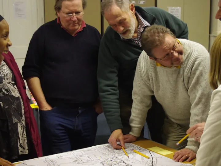 community group discussing over a map