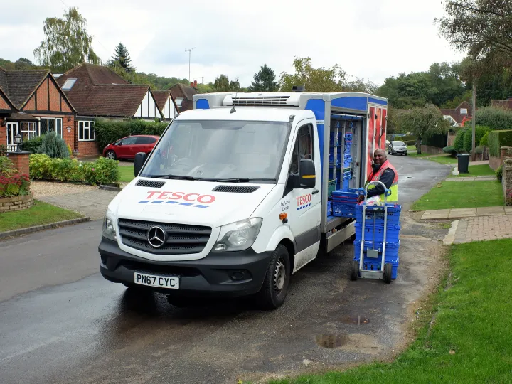 grocery delivery truck unloading in suburbs