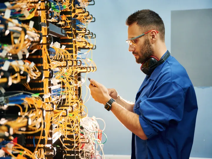 Man looking at internet modems