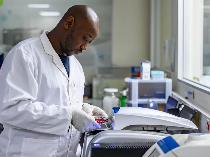 Male researcher using a machine